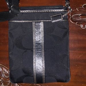 Black Coach small crossbody measure 6.5in. wide by 8 in. Straps adjust.